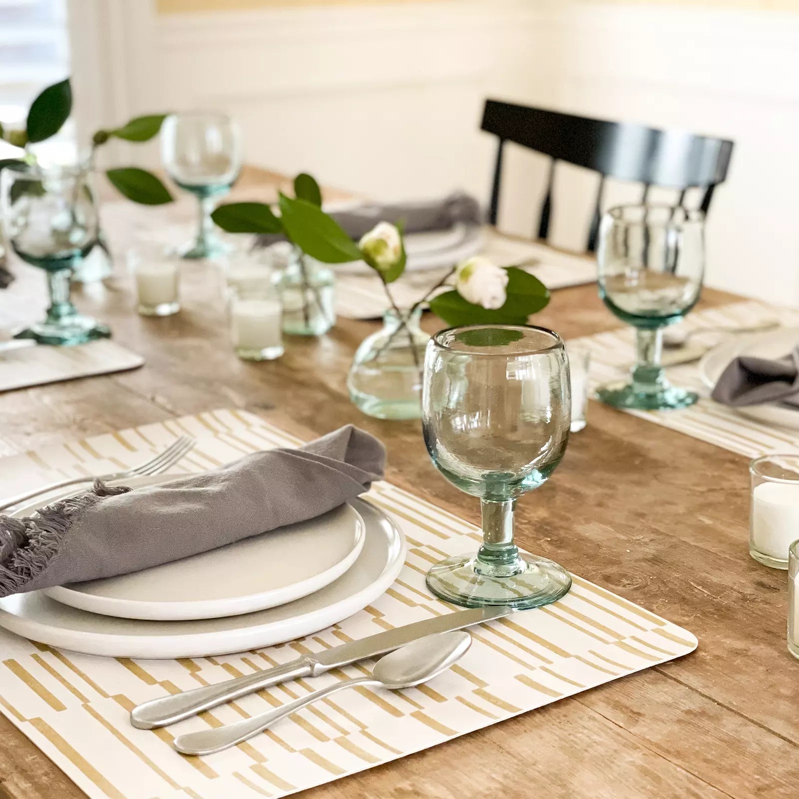 Nara Ochre Yellow Striped place mat at table setting with plate, napkin and silverware