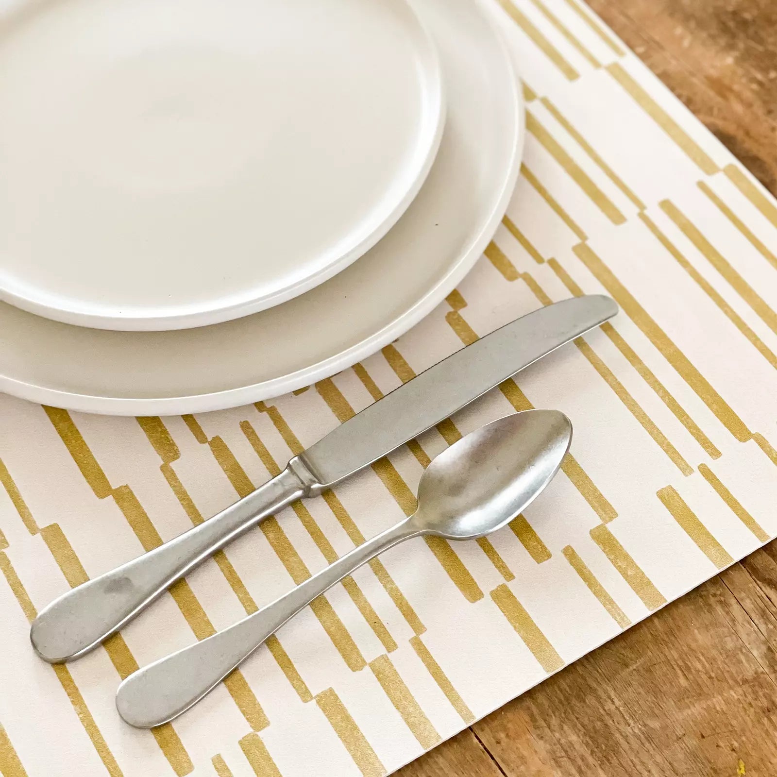 Nara Ochre Yellow Striped place mat up close with plate and silverware