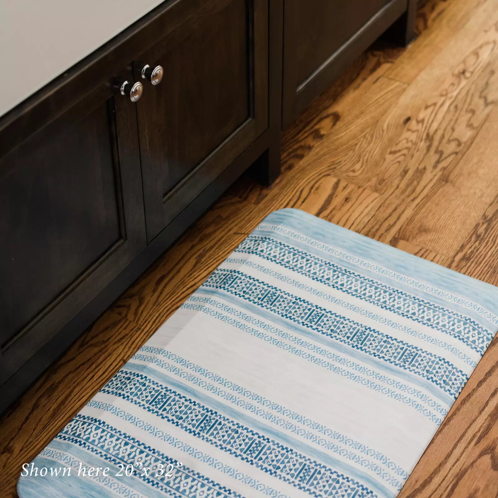 Blue and white boho stripe kitchen mat in kitchen shown in size 20x32