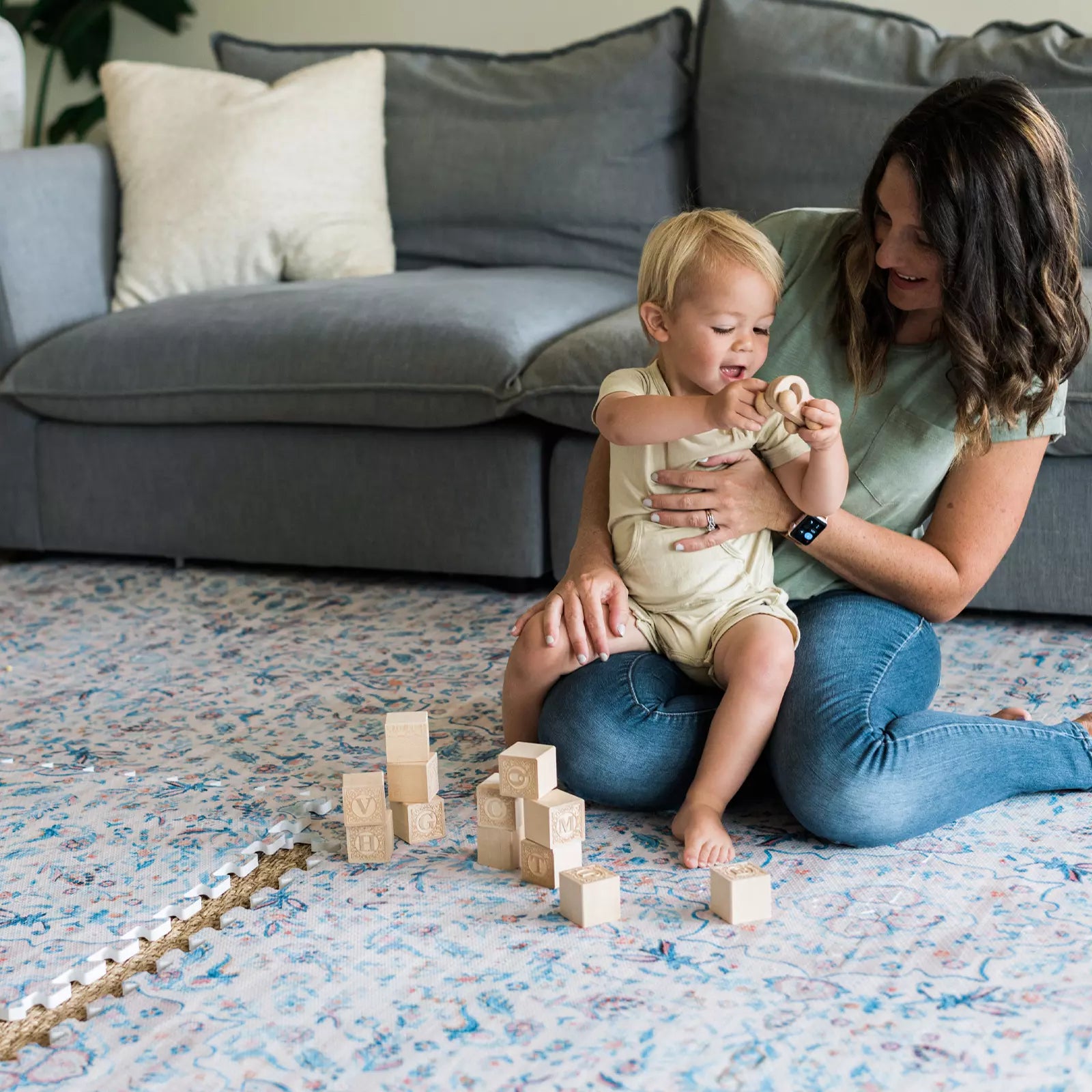 Emile Pale Aqua Blush Floral Boho Baby Play Mat with baby and mom playing with blocks