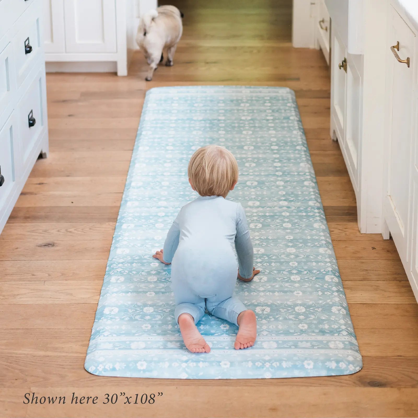 Nama standing mat Gemma sea blue floral with baby in kitchen shown in size 30x108