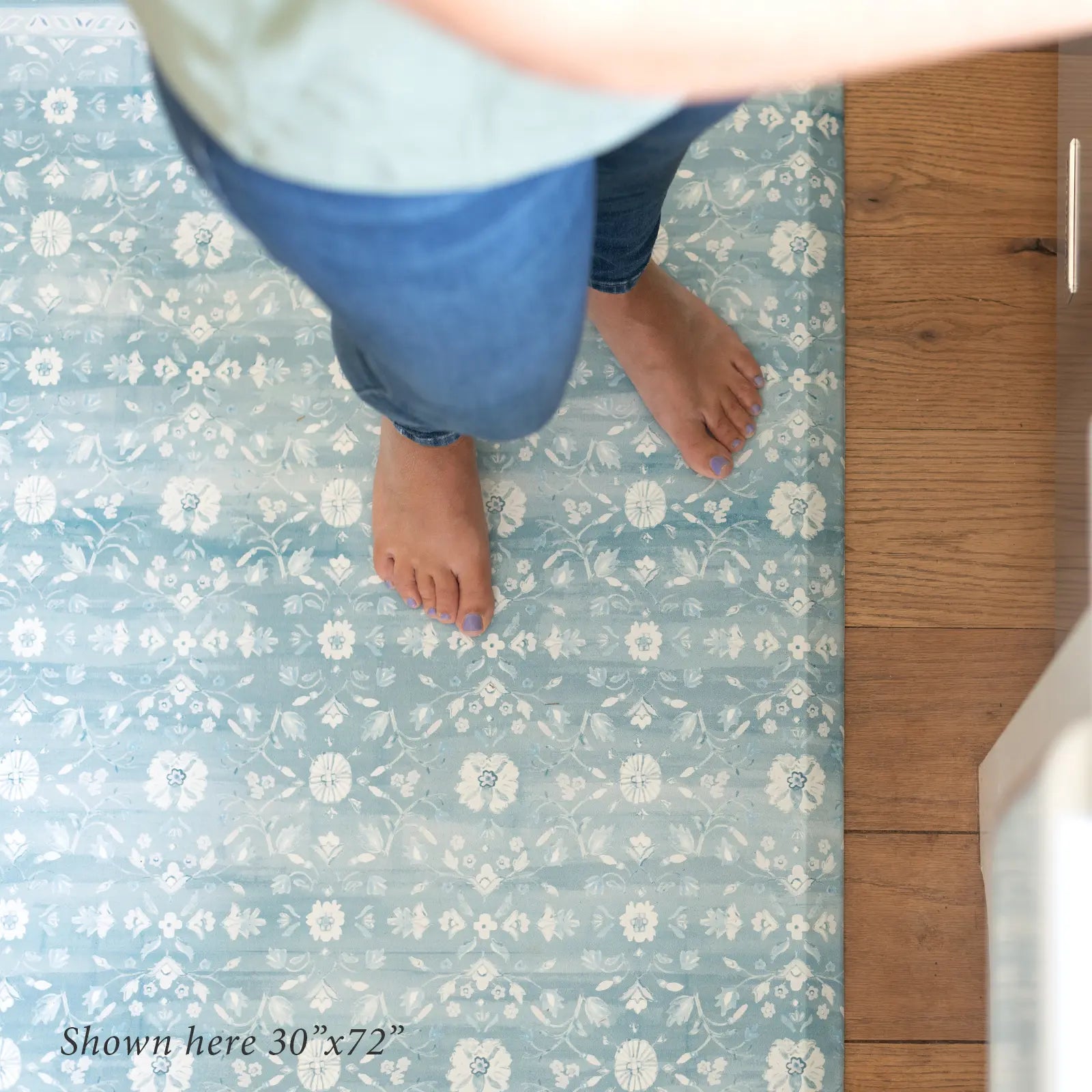 Nama standing mat Gemma sea blue floral shown from above in kitchen with womans feet shown in size 30x72