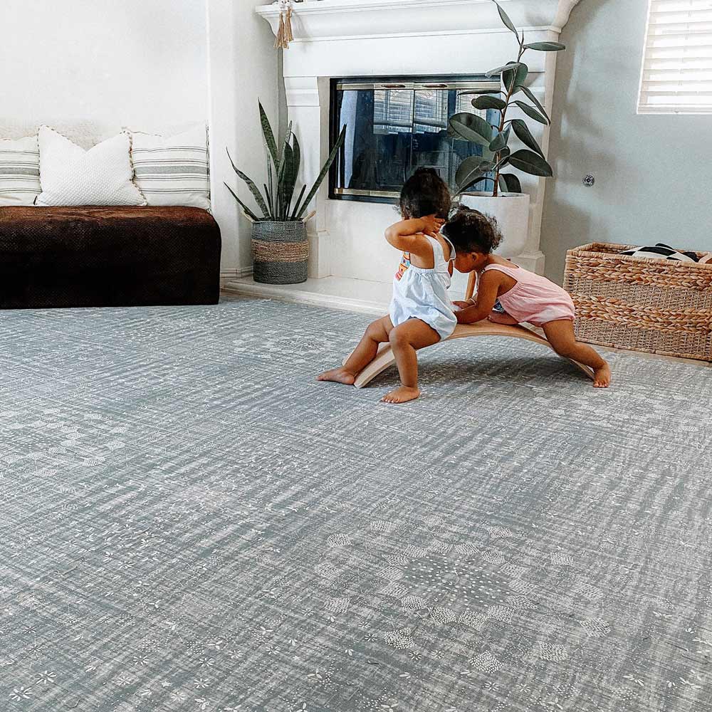 Silver Lining gray play mat in living room with babies playing