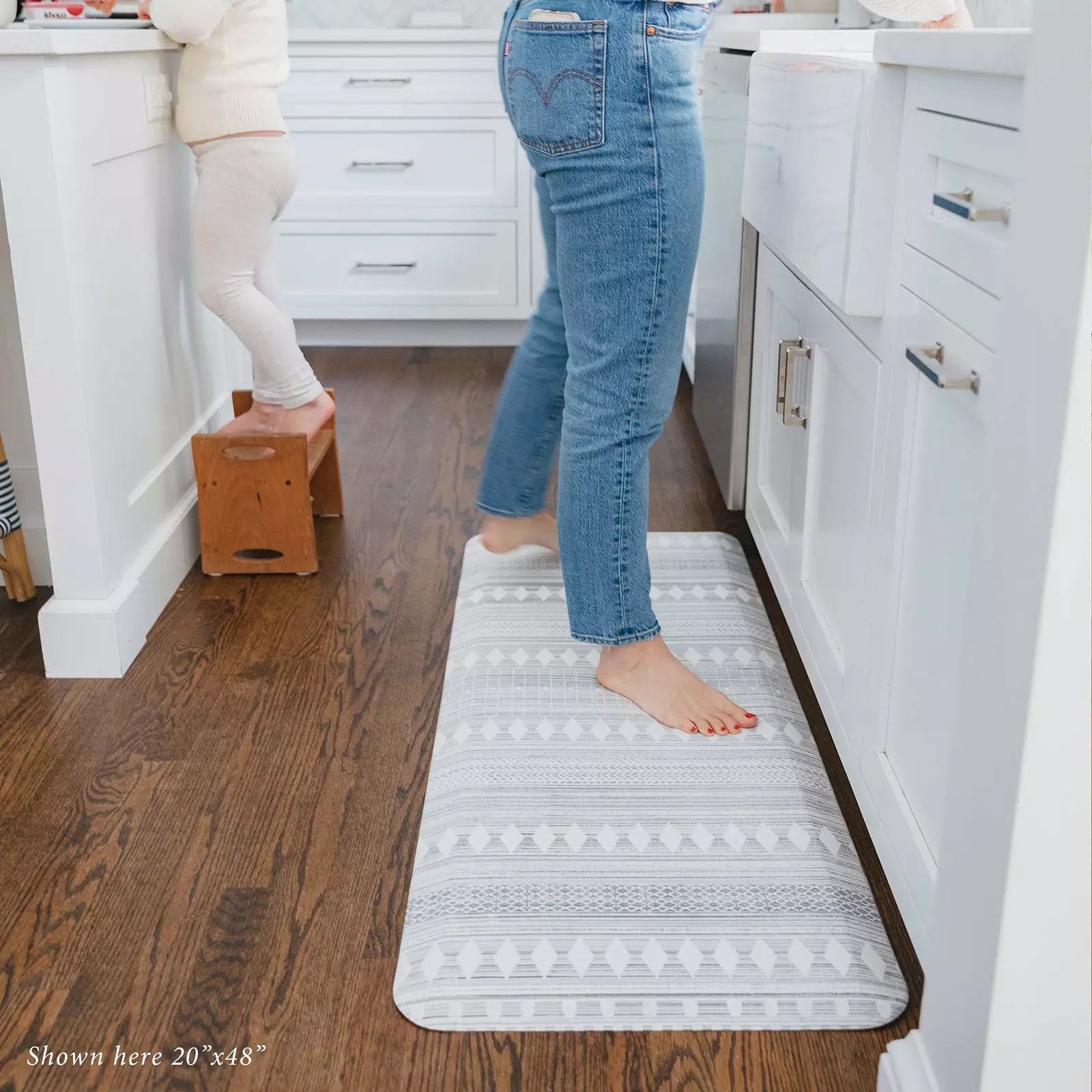 Nordique Fog Gray and White Boho Nordic Print Standing Mat in kitchen with woman washing dishes