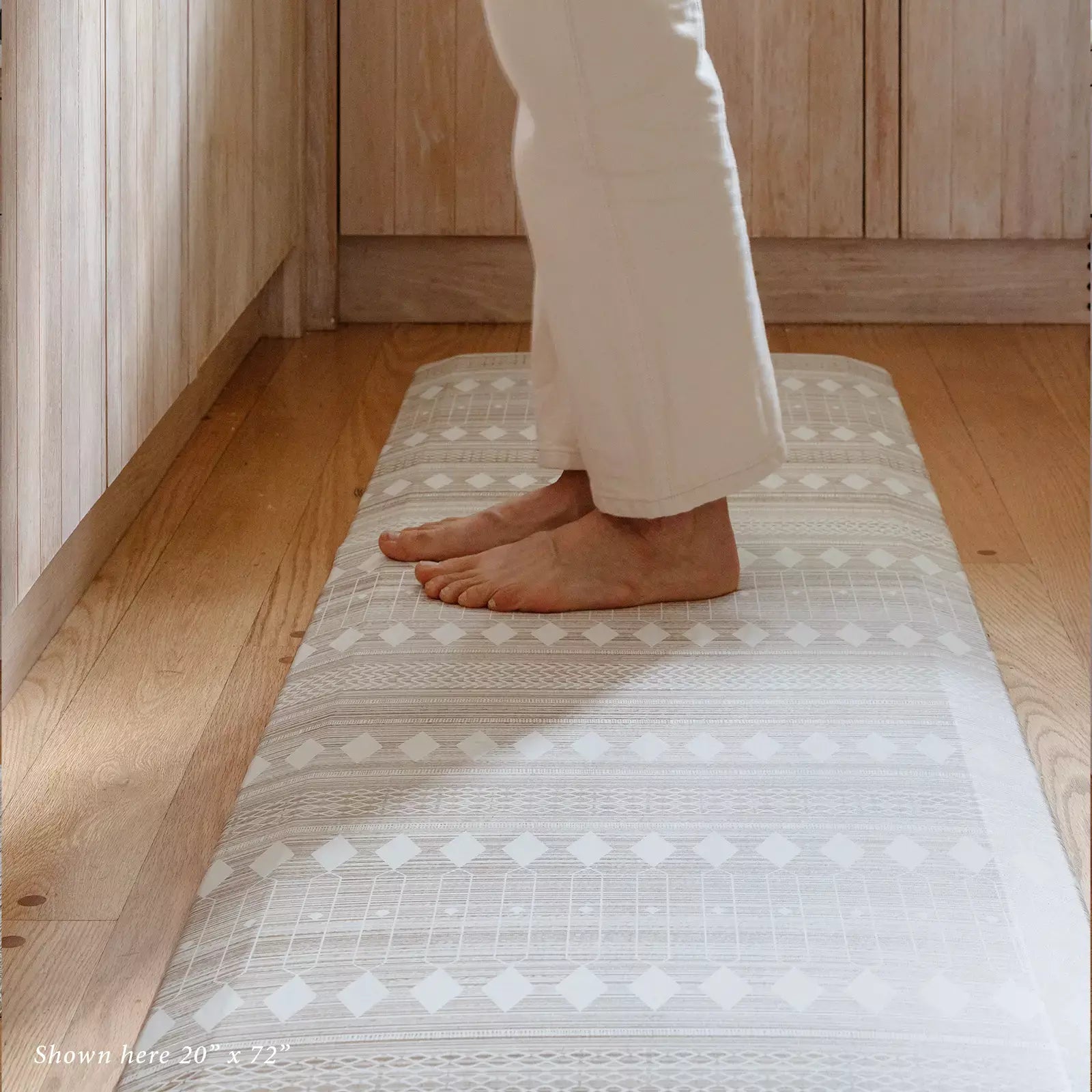 Beige and White Boho Nordic Print kitchen Mat shown with woman standing on size 20x72